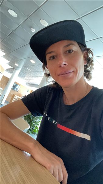 Portrait of Ana Gay in a cap and Dr. Bike T-shirt